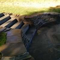 blue stone dimensional steps with dry stack retaining wall and patio with firepit